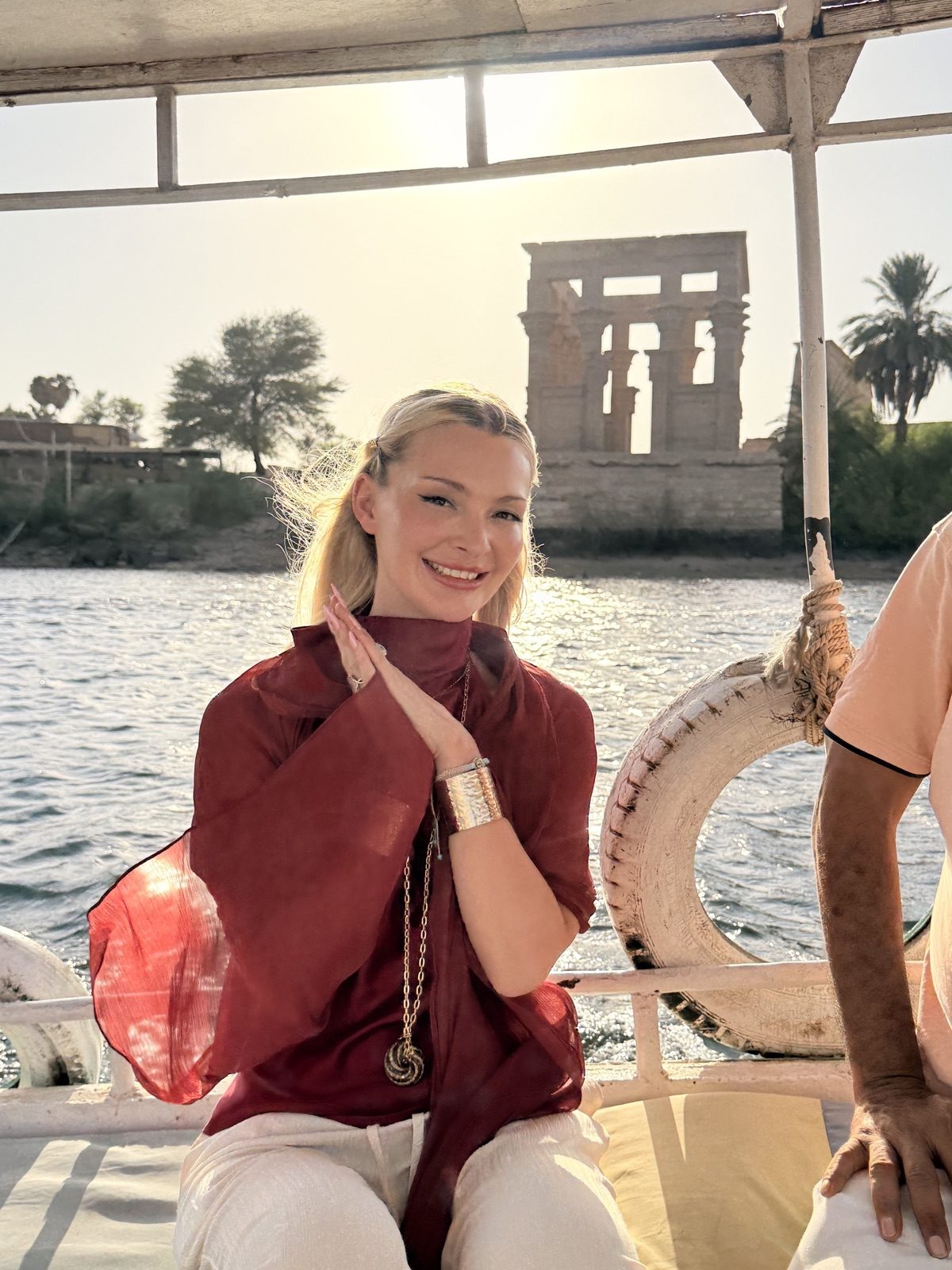 Sian Elizabeth wearing the Garnet Torus Field necklace on the Nile at Philae